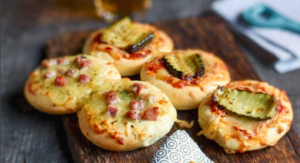mini pizzas on a wooden tray