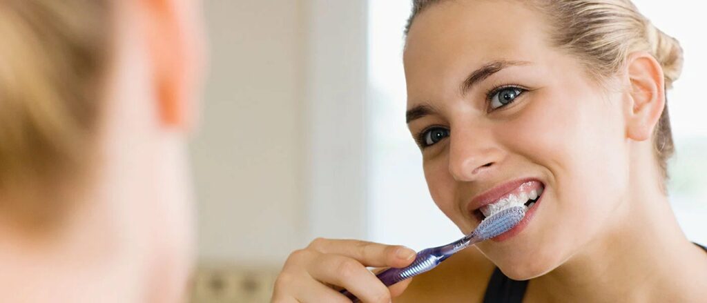 woman brushing teeth