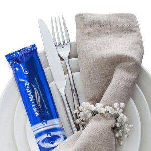 wet nap packet with cutlery on plate