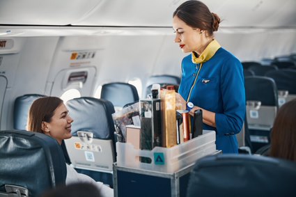 female air hostess serving from a trolley