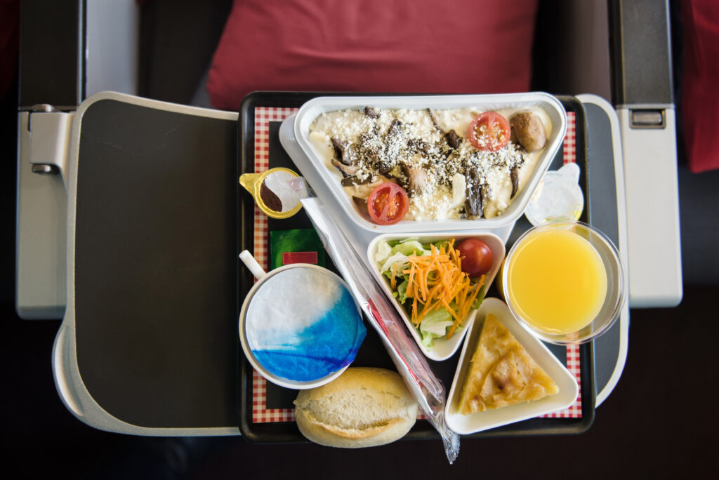 Food served on board of airplane on the table.