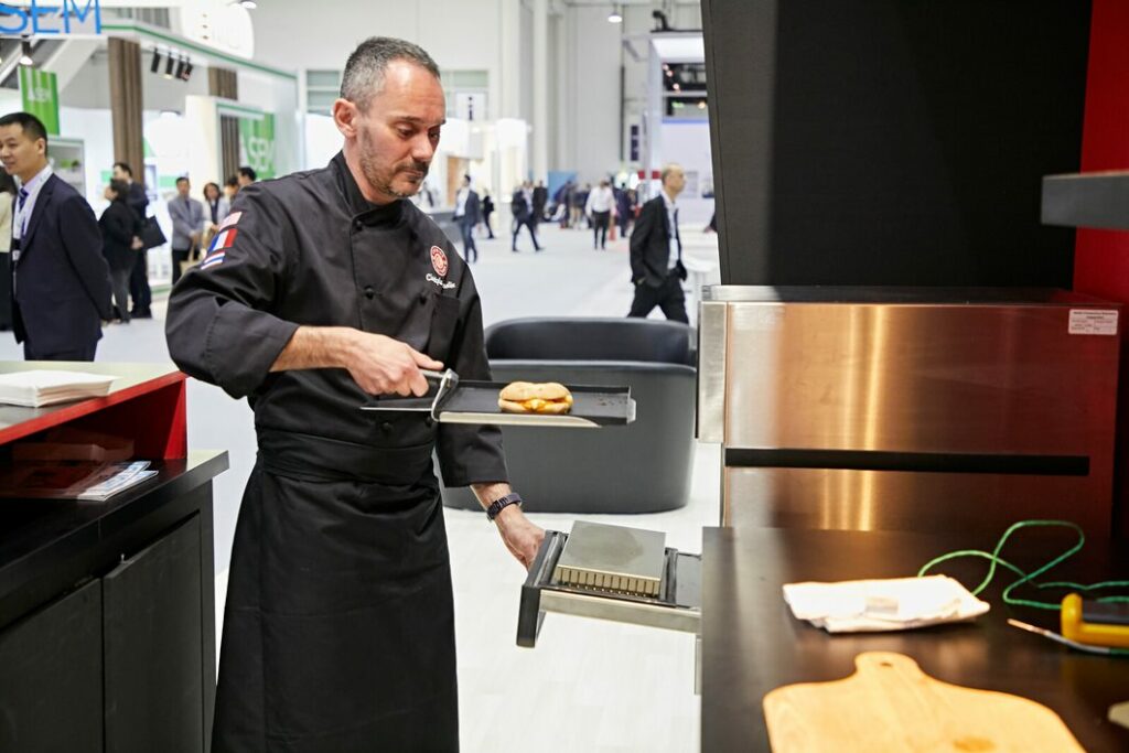 chef at wtce using tray and an oven