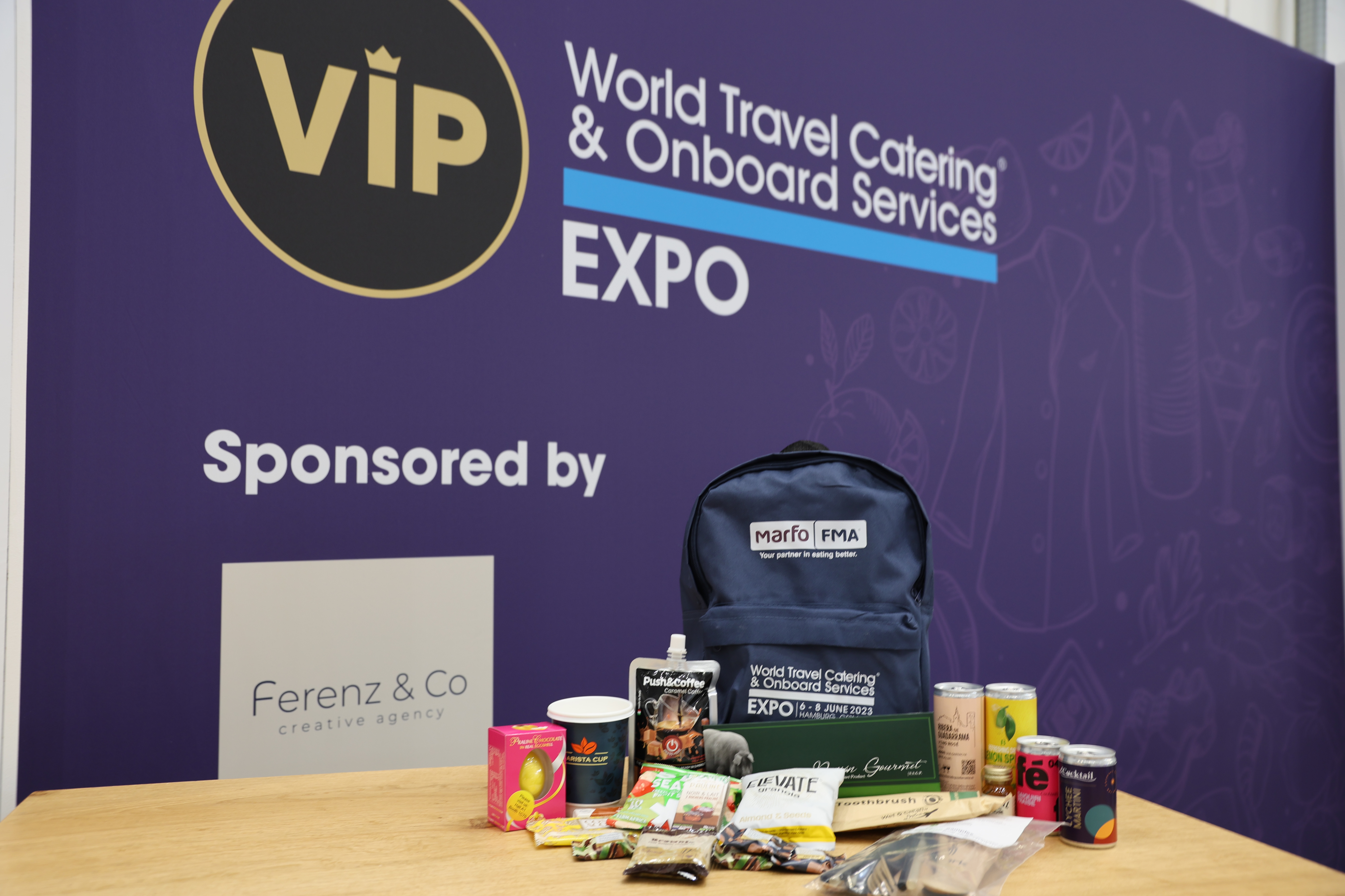 wtce vip bag with sample products in front of purple sign
