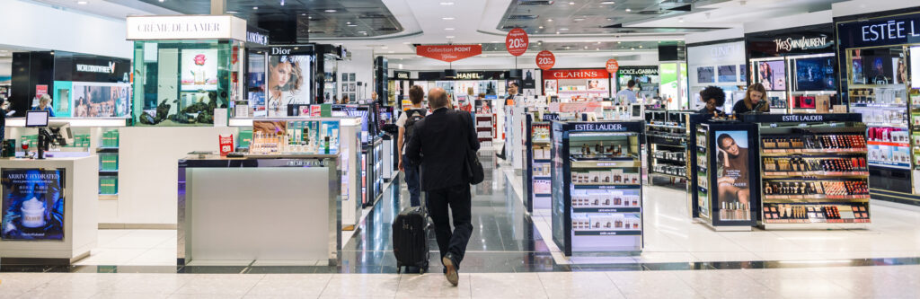 man walking through Heathrow duty free