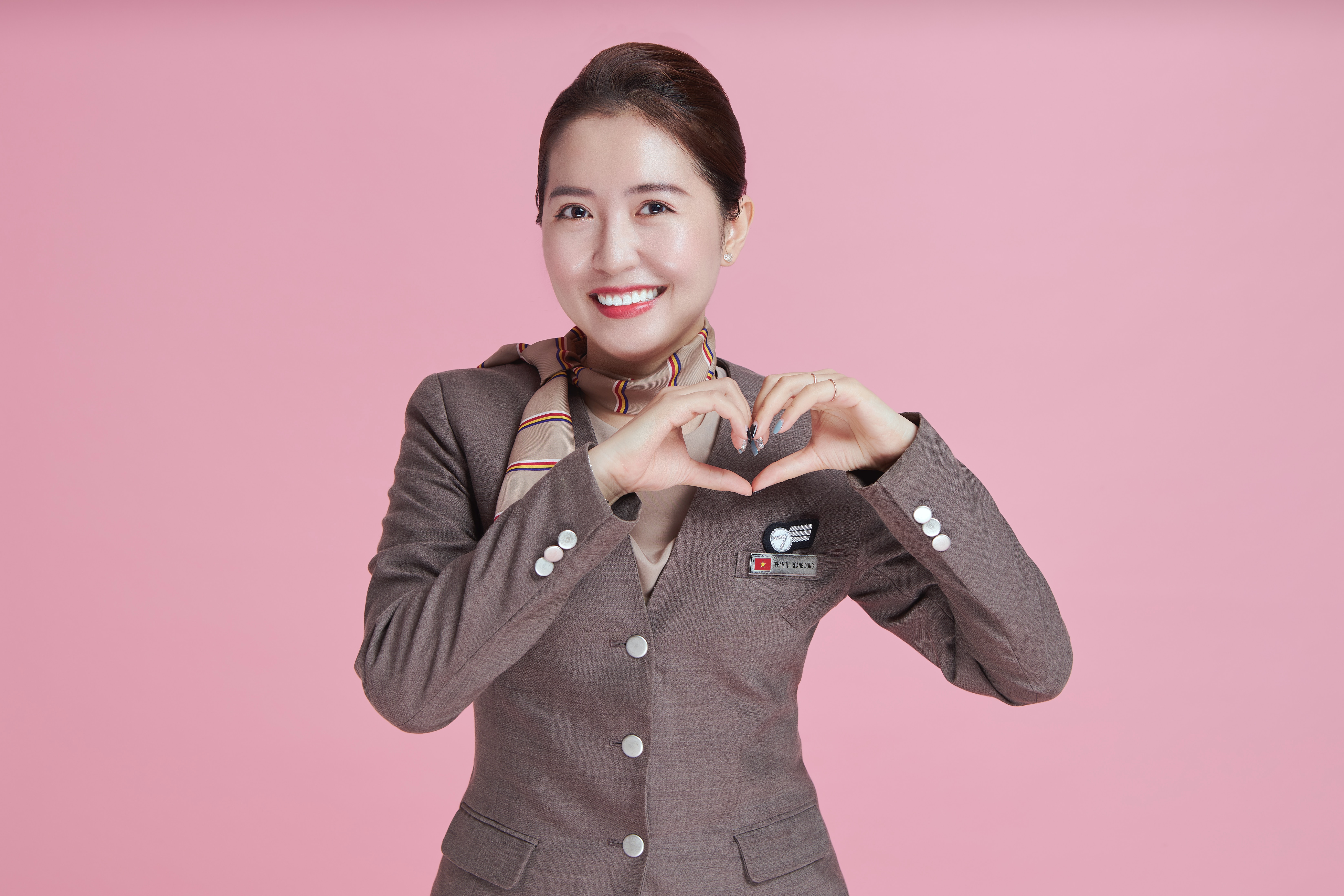 female airline hostess doing love heart emote