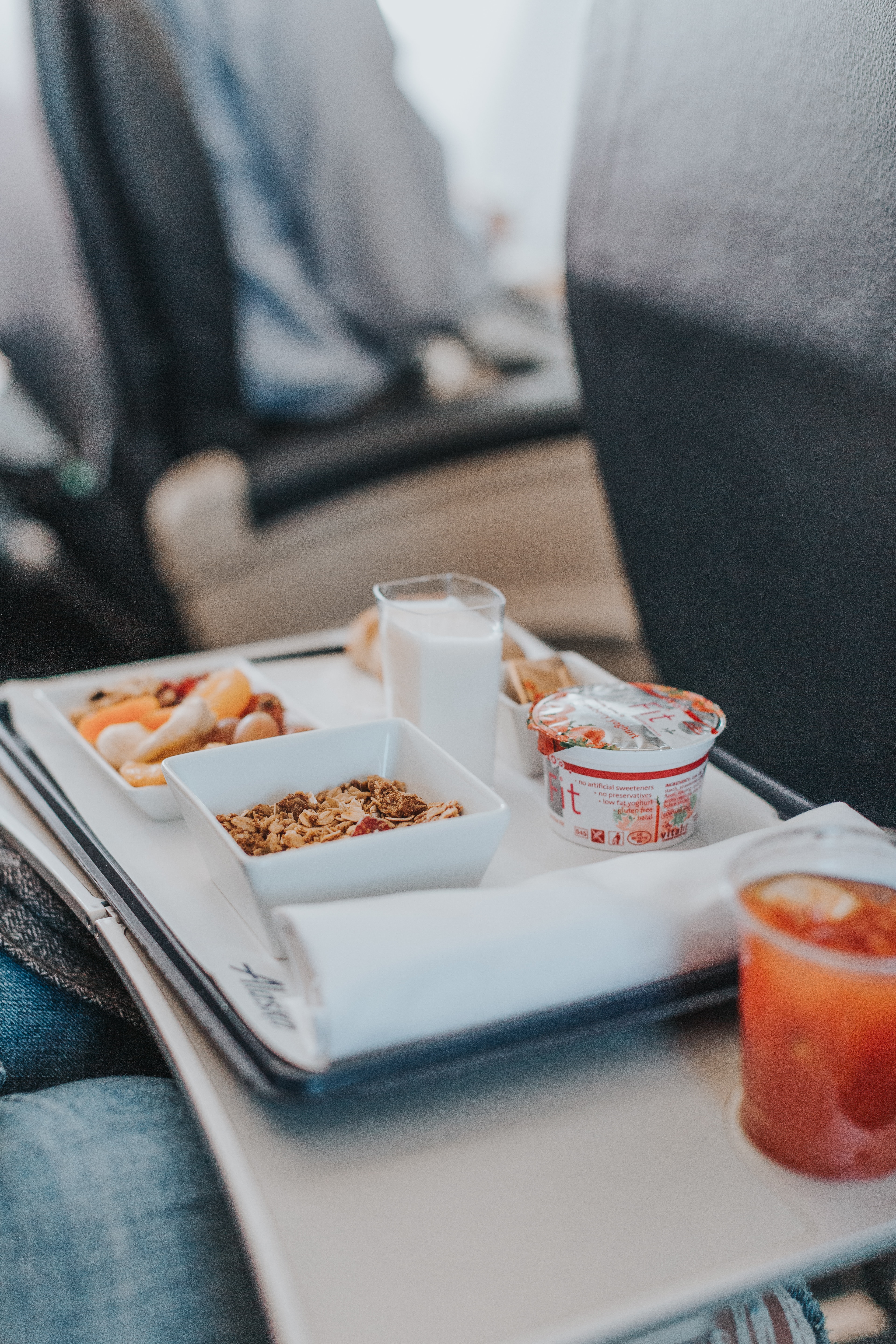 airplane breakfast with yoghurt and cereal on tray table