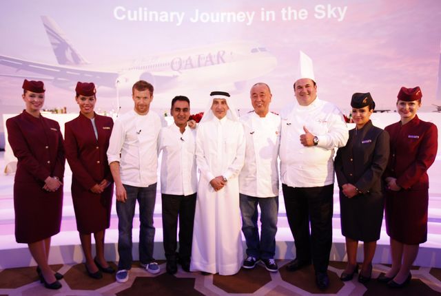 qatar chefs and airline crew in front of banner